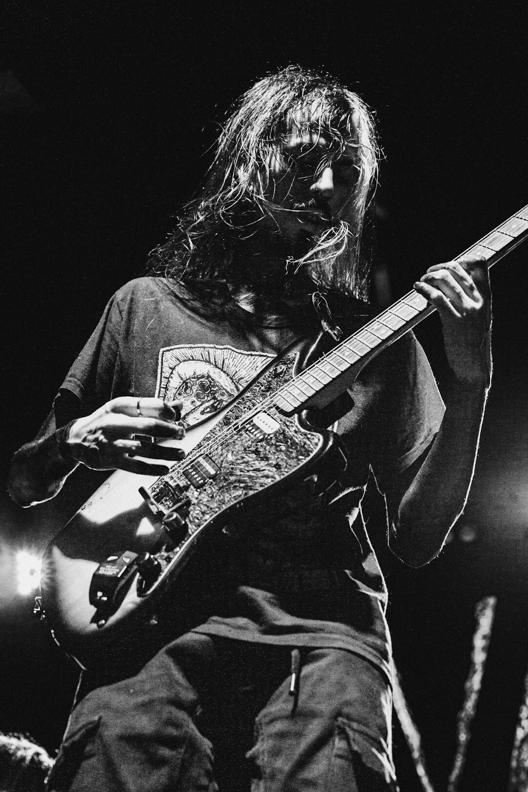 Black and white portrait of an Argentine musician holding a guitar