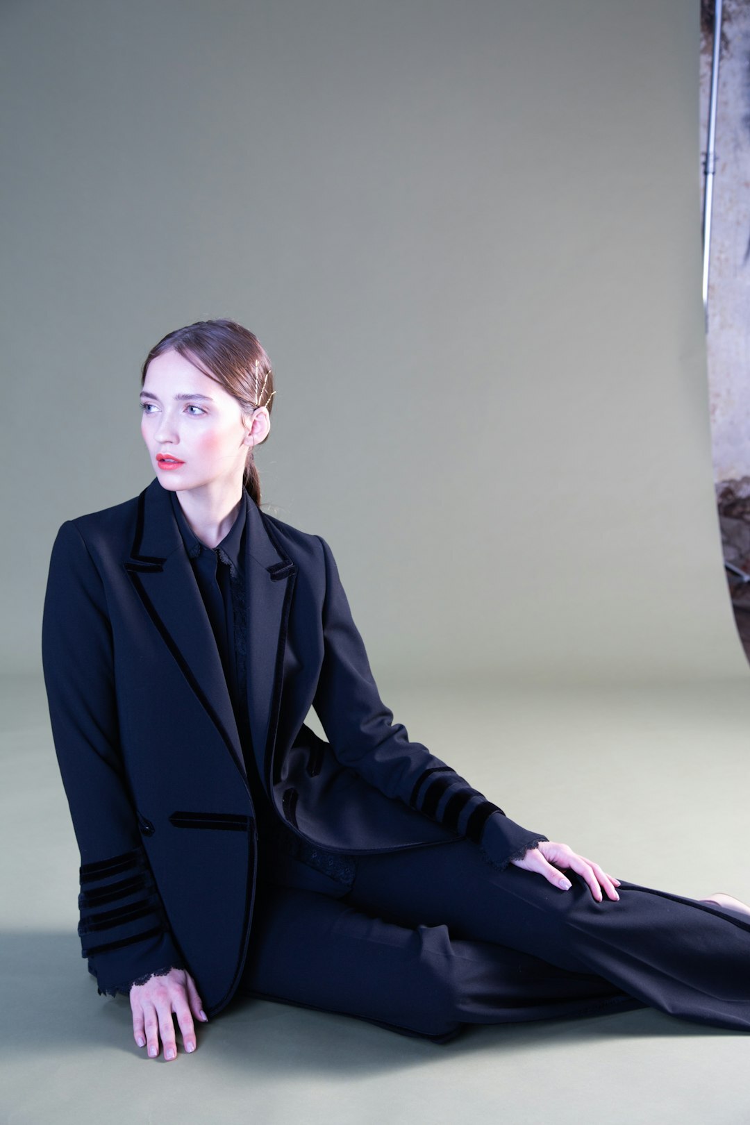 Fashion model wearing a designer tailored suit in a studio lookbook shot